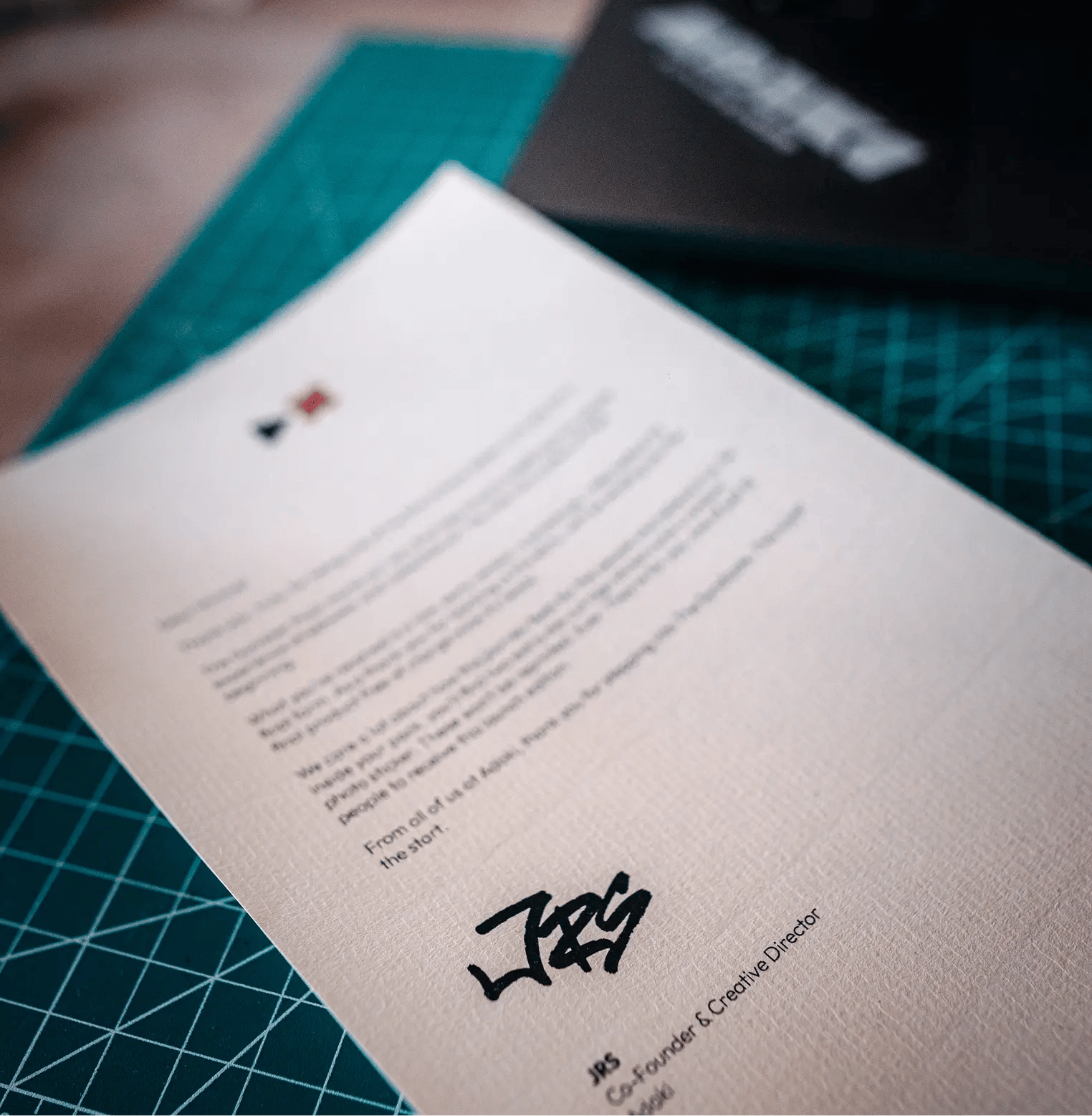 A photograph of an Adaki headed thank you letter with a hand written signature from JRS